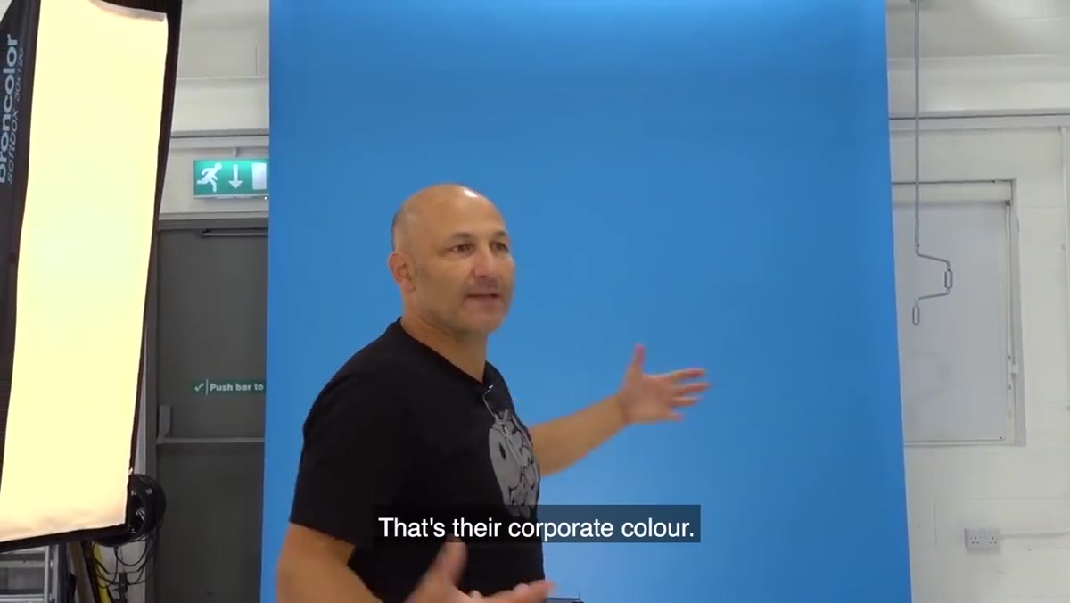 Blue branded backdrop with gradient glow from background light
